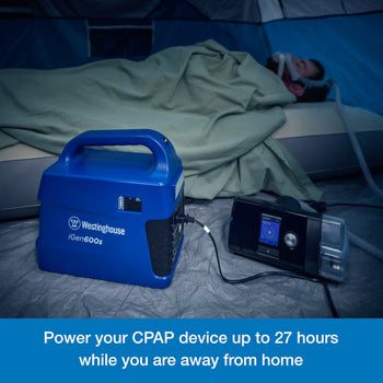 Westinghouse | iGen600s Portable Power Station is shown on the floor of a tent powering a CPAP machine. A man wearing the sleep apnea mask is sleeping on an air mattress in the background. A blue banner along the bottom reads,