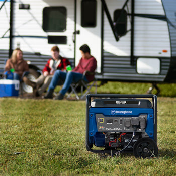 Westinghouse | WGen5300sc portable generator is in the foreground. A camper with three people sitting outside of it are in the background.