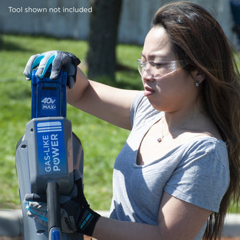 A woman plugs in the battery into a 40V cordless tool