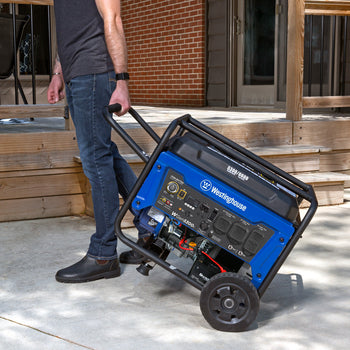 Westinghouse | WGen5300c portable generator shown being pulled to a backyard with a patio in the background.