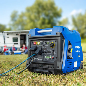 Westinghouse | iGen4500 inverter generator sitting in grass with a camper and people in the background.
